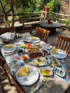 a table with plates of food on top of it at Vama Konuk Evi in Gokceada Town +36 photos