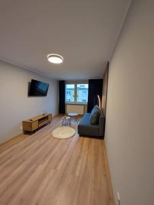a living room with a couch and a table at Aparto 1 in Złotów +4 photos