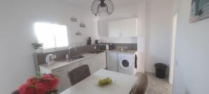 a kitchen with a sink and a washing machine at Kamer Appartement in Arico in La Sabinita
