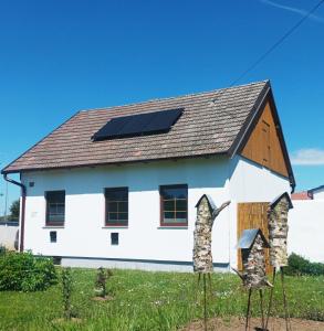 a white house with solar panels on the roof at Ferienhaus-Weinmeyer in Paasdorf
