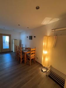 a kitchen and dining room with a table and chairs at Haus Waldesruh, 3 Ferienwohnungen in Hemfurth-Edersee