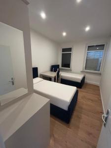 a small room with two beds and a desk at Ferienwohnung in Glauchau +5 photos