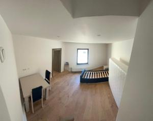 an empty room with a couch and a table and a window at Ferienwohnung in Glauchau
