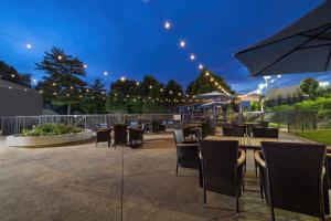 a patio with tables and chairs and an umbrella at Delta Hotels by Marriott Nashville Airport in Nashville