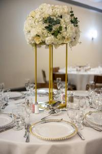 a table with a flower arrangement on top of a table at Delta Hotels by Marriott Nashville Airport in Nashville +62 photos