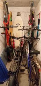 two bikes parked against a wall with a surfboard at Sportrek House in Levanto