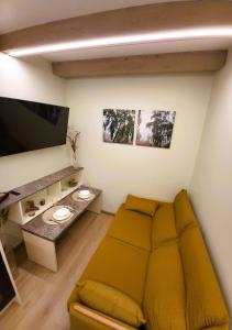 a living room with a couch and a table at Ežiukų rojus in Neringa +4 photos