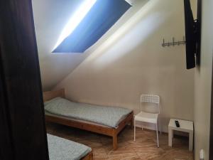 a small room with a bed and a chair at Comfort Akacija Apartments in Vilnius