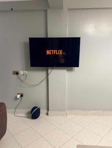 a netflix sign on a wall in a room at Backpackersnest in Entebbe