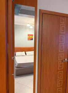 a door leading to a bedroom with a bed in a room at Backpackersnest in Entebbe