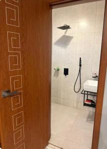 a bathroom with a shower and a sink at Backpackersnest in Entebbe