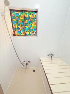 a bathroom with a stained glass window on the wall at aiki home in Tokyo +25 photos