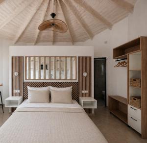 a bedroom with a large bed and a ceiling at Lux Studios With Private Pool by ILIOS Georgioupoli in Georgioupoli +31 photos