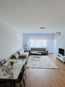 a living room with a couch and a table at Reinas Apartment in Prizren