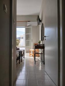a hallway with a table and a dining room at Andromeda in Ios Chora