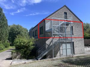 a building with a ladder on the side of it at Secret garden 3 in Mellehoek
