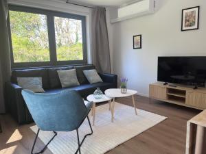 a living room with a couch and a tv at Secret garden 3 in Mellehoek
