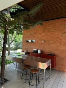 a kitchen with a table and two stools at Villa At On Organic Farm in Ban Wak
