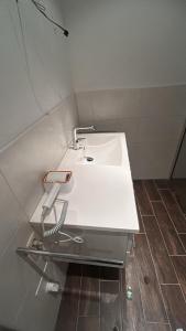 a bathroom with a white sink with a phone on it at Ferienwohnung in Glauchau
