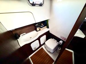 a small bathroom with a sink and a toilet at VIP JACHT in Polańczyk