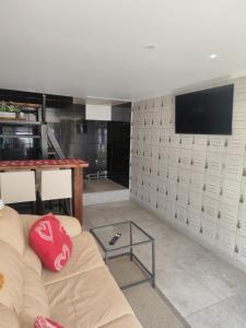 a living room with a couch and a flat screen tv at Comfort Akacija Apartments in Vilnius