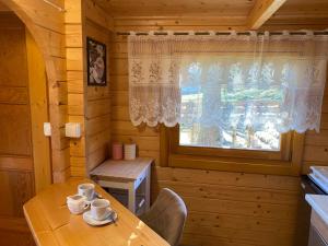 a dining room with a table and a window at Domek pod Świerkiem in Wapnica