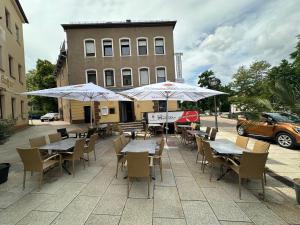 an outdoor patio with tables and chairs and umbrellas at Ferienwohnung in Glauchau