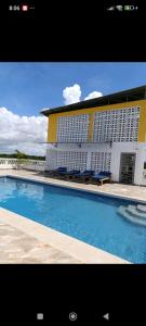 a building with a swimming pool in front of a building at Casa Marabella in Diani Beach