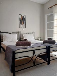 a bedroom with two beds with towels on them at Andromeda in Ios Chora