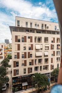 a large apartment building with a balcony at Agate Hotel Tirana in Tirana