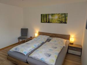 a bed in a room with two lights on at Ferienwohnung 's Stüble in Schönwald