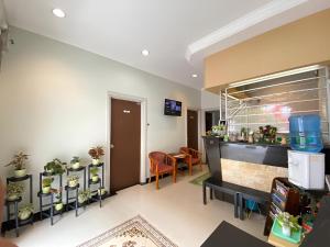 a living room filled with lots of potted plants at Perdana Hotel Labuan in Labuan