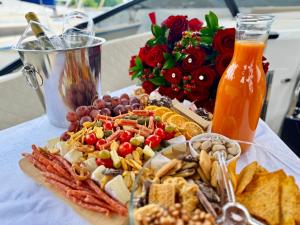a platter of food with a drink and a bouquet of roses at VIP JACHT in Polańczyk +47 photos