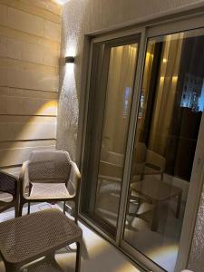 a balcony with chairs and tables on a building at Sun gate house in Cairo +42 photos