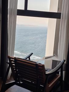 a bench sitting in front of a window with the ocean at Mandala Chambay Mũi Né - TAQ in Mui Ne +9 photos