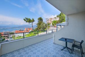 a balcony with a table and a view of the water at Miralya Rooms in Fethiye