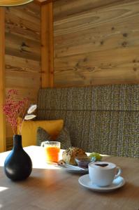 a table with a plate of food and a cup of coffee at Landhaus Riedl in Bad Füssing