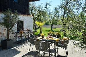 a patio with a table and chairs and a fireplace at Landhaus Riedl in Bad Füssing +55 photos