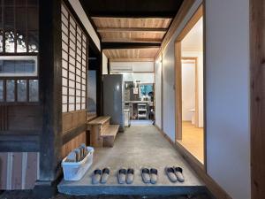 a group of shoes sitting on the floor of a room at 古民家宿 Mutsu Traditional Japanese House Inn MUTSU in Ōtaki