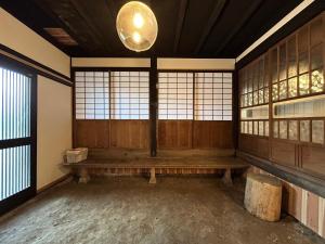 an empty room with a bench in a room with windows at 古民家宿 Mutsu Traditional Japanese House Inn MUTSU in Ōtaki +46 photos