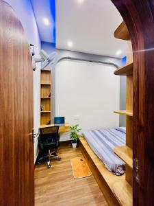a bedroom with a bed and a desk in a room at Ruby Home Quy Nhon in Quy Nhon
