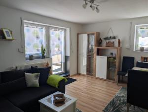 a living room with a couch and a table at Ferienwohnung 's Stüble in Schönwald