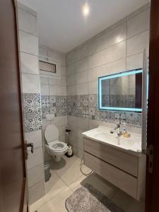 a bathroom with a sink and a toilet at Sublime appartement F4 a draria in Alger +8 photos