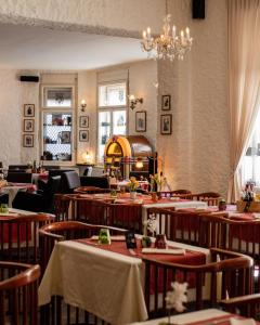 a restaurant with tables and chairs and a chandelier at B&B Fotić in Zagreb
