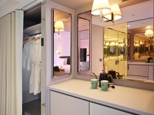 a bathroom with a sink and a mirror at OOD Hotel Taipei DunhuaNorth in Taipei