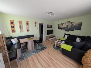 a living room with a couch and a table at Ferienwohnung 's Stüble in Schönwald
