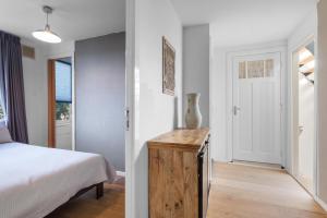 a bedroom with a bed and a table with a vase on it at Bed zonder Breakfast in Amsterdam