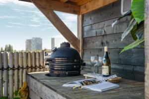 a table with a bottle of wine and wine glasses at Bed zonder Breakfast in Amsterdam +5 photos