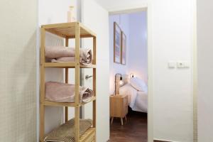 a bathroom with a wooden shelf with towels at Duplex con vistas en el centro de Aracena in Aracena