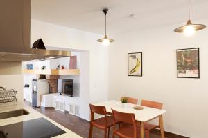 a kitchen and dining room with a table and chairs at Duplex con vistas en el centro de Aracena in Aracena